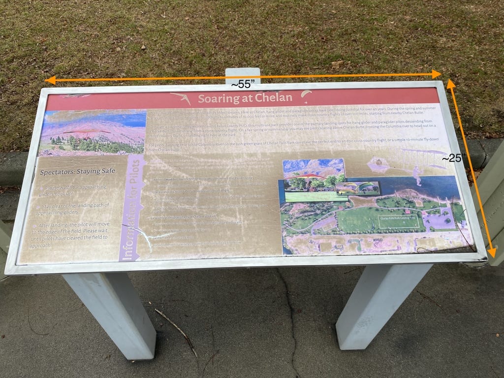 The original "Soaring at Chelan" panel, sun-bleached to the point that most of the text and photographs have faded out.
